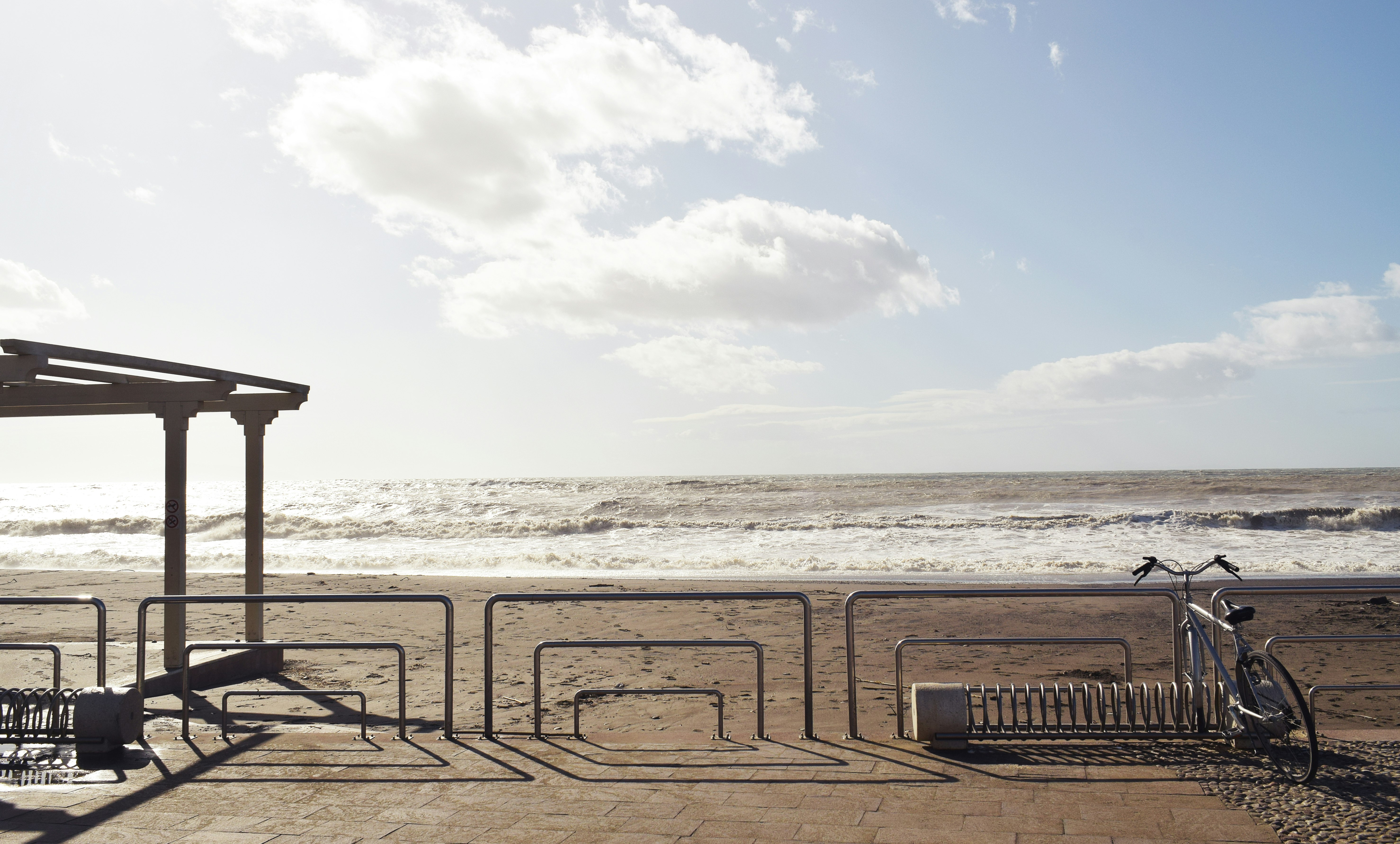 brown wooden fence on beach during daytime